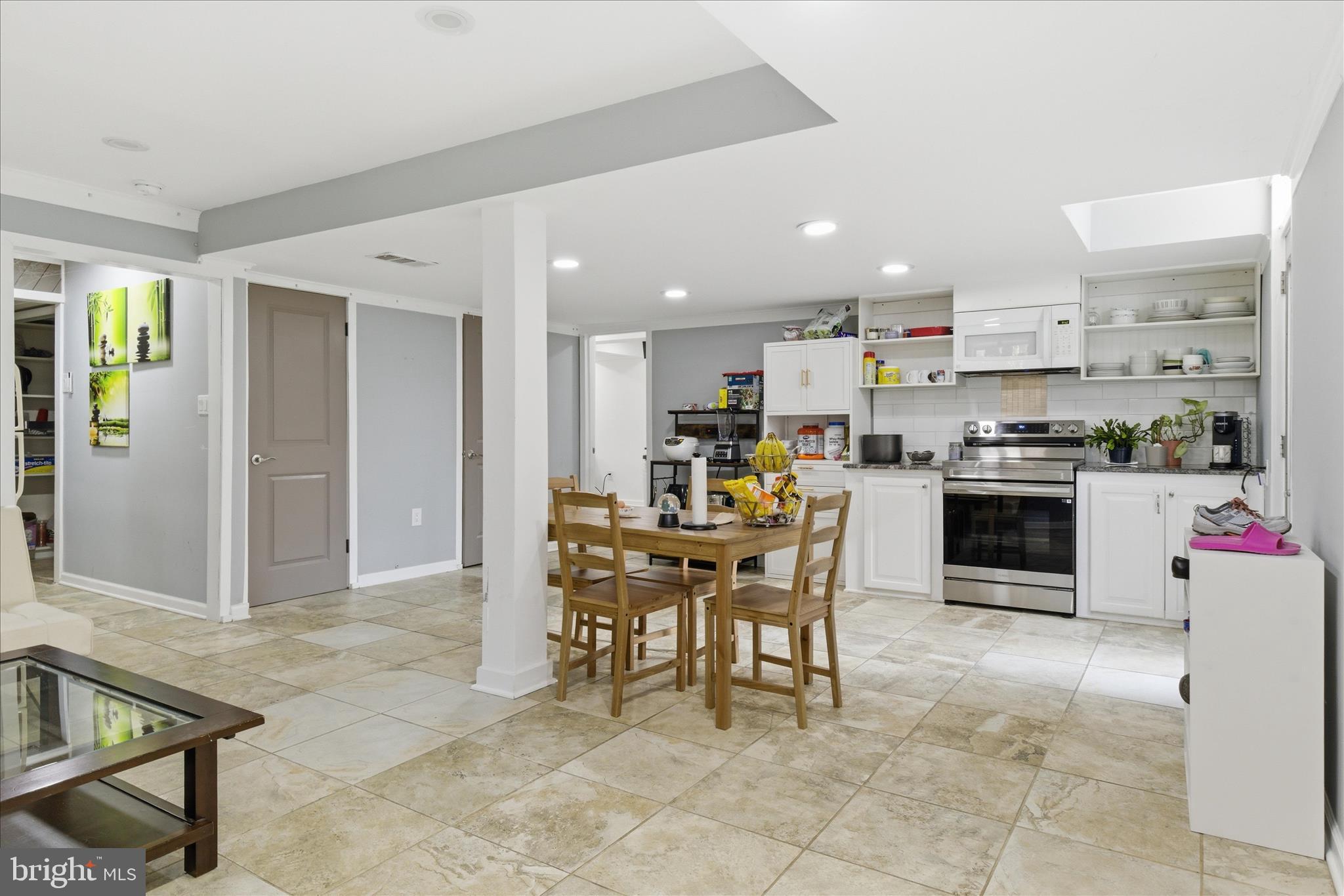 5515 Westcliff Court Burke, VA 22015 - Photo 33 of 47 a kitchen with kitchen island a dining table chairs and white cabinets