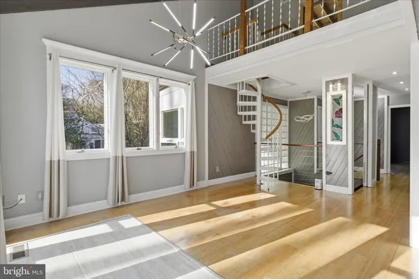 a view of a hallway with wooden floor and a fireplace