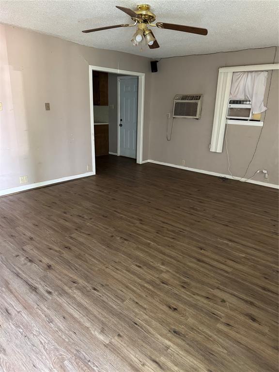 407 West 12th Street Quanah, TX 79252 - Photo 2 of 11 wooden floor in an empty room