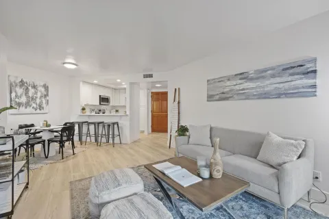 a living room with furniture and view of kitchen