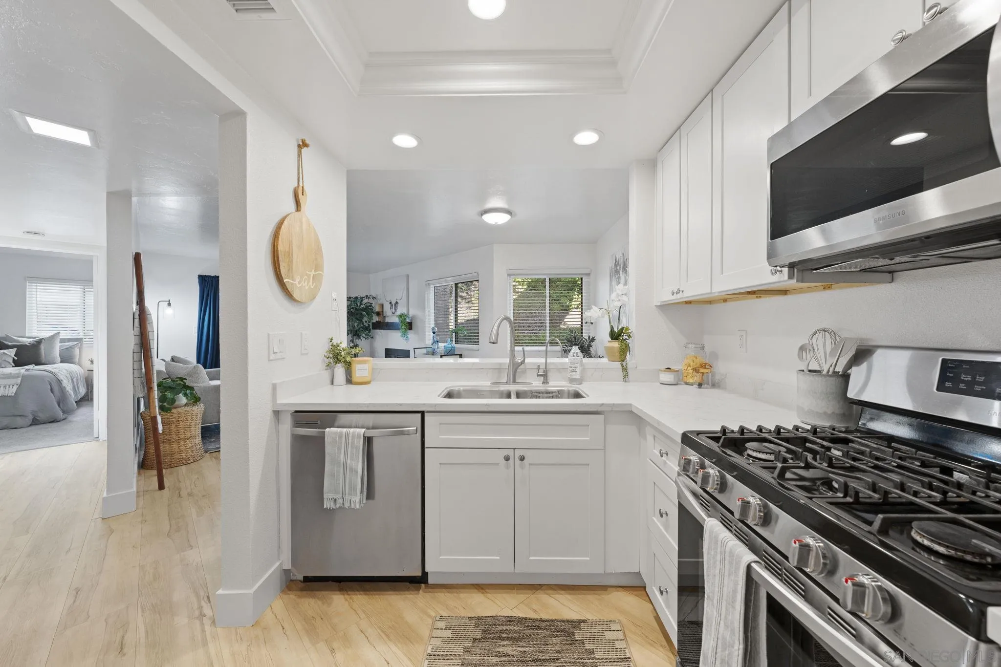 3002 Blue Oak Court Spring Valley, CA 91978 - Photo 7 of 23 a kitchen with a sink stove and cabinets