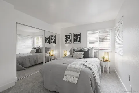 a bedroom with a large bed and a couch