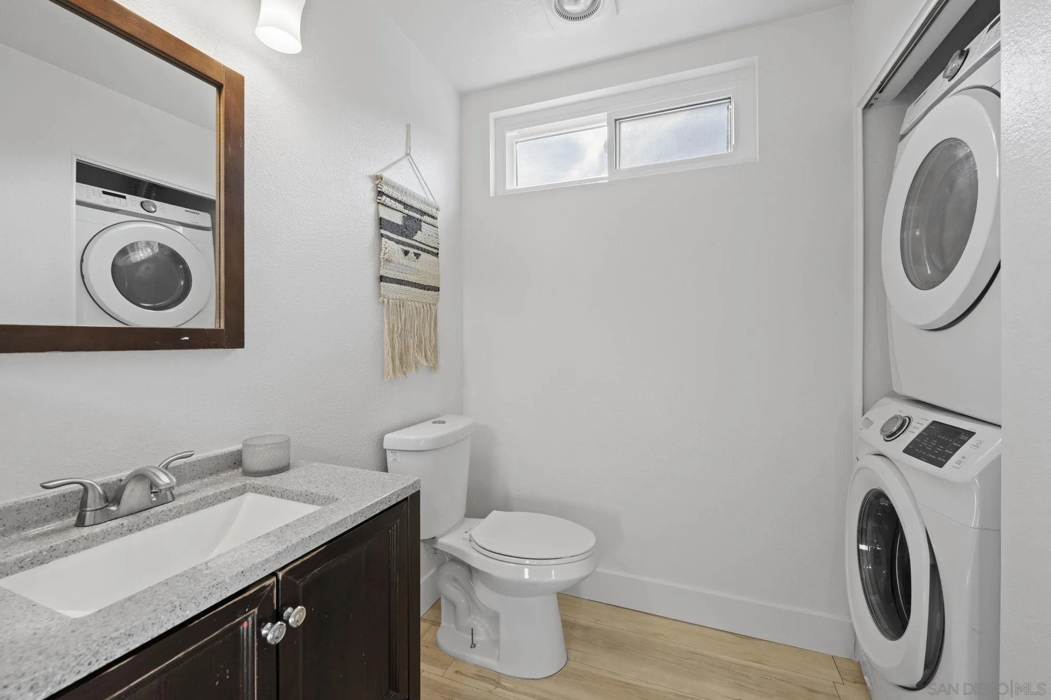 3002 Blue Oak Court Spring Valley, CA 91978 - Photo 10 of 23 a bathroom with a toilet a sink and a mirror