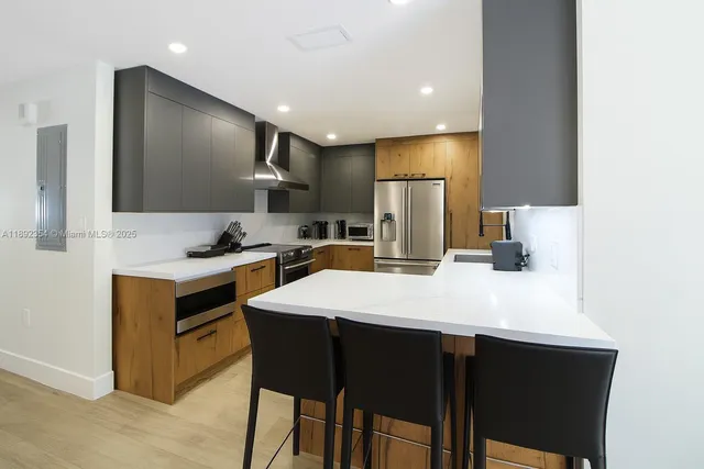 a kitchen with a refrigerator and a sink