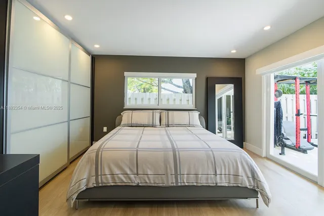 a bedroom with a large bed and a large window