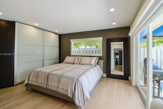 a bedroom with a large bed and a large window