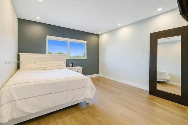 a bedroom with a bed and a mirror