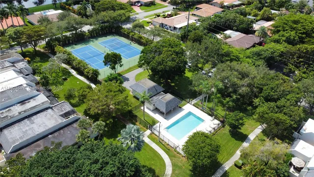 an aerial view of residential house with outdoor space and swimming pool