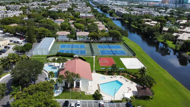 an aerial view of residential houses with outdoor space and parking
