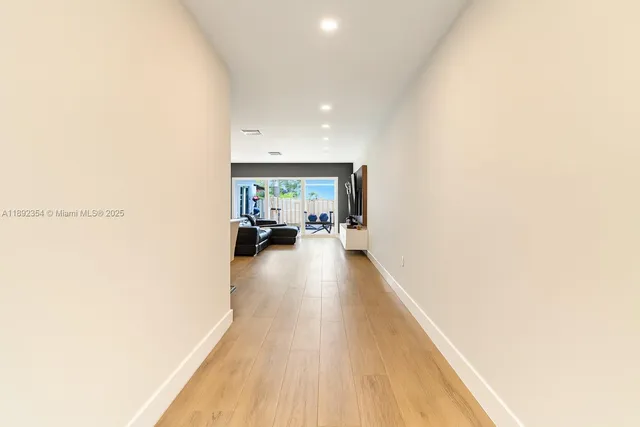 a view of a living room hardwood and kitchen
