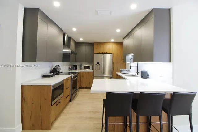 a large kitchen with a table and chairs