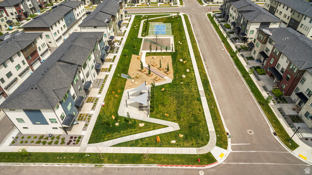 765 Crystal Crk Road American Fork, UT 84003 - Photo 27 of 27 Modern townhome community featuring contemporary architectural facades, a central green space, dedicated pathways, a shaded playground area, and a sports court