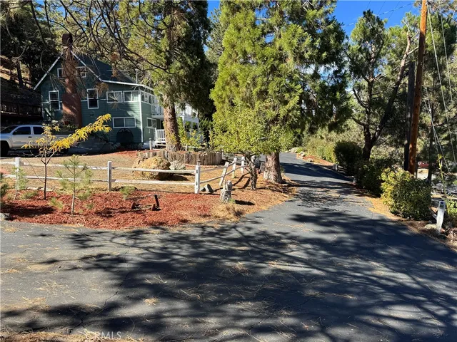 a view of swimming pool with a yard and wooden fence