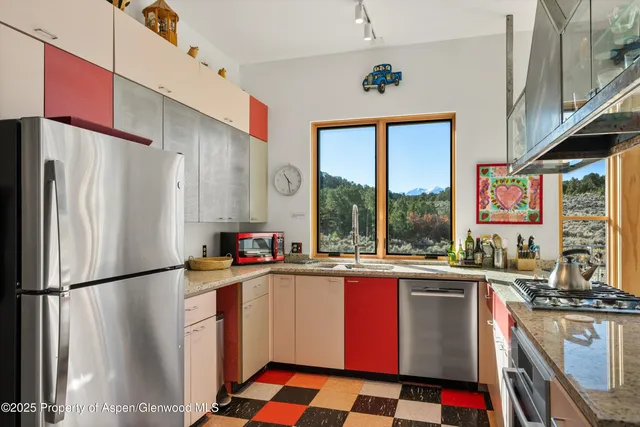 a kitchen with stainless steel appliances a sink a stove and a refrigerator