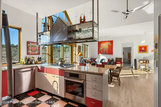 a open kitchen with stainless steel appliances granite countertop a stove and a refrigerator