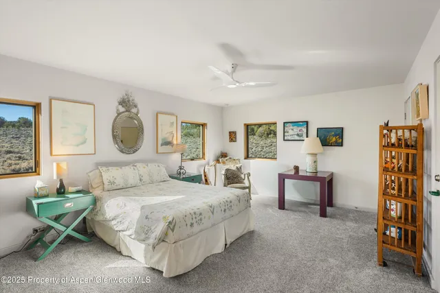 a bedroom with a bed couch and a window