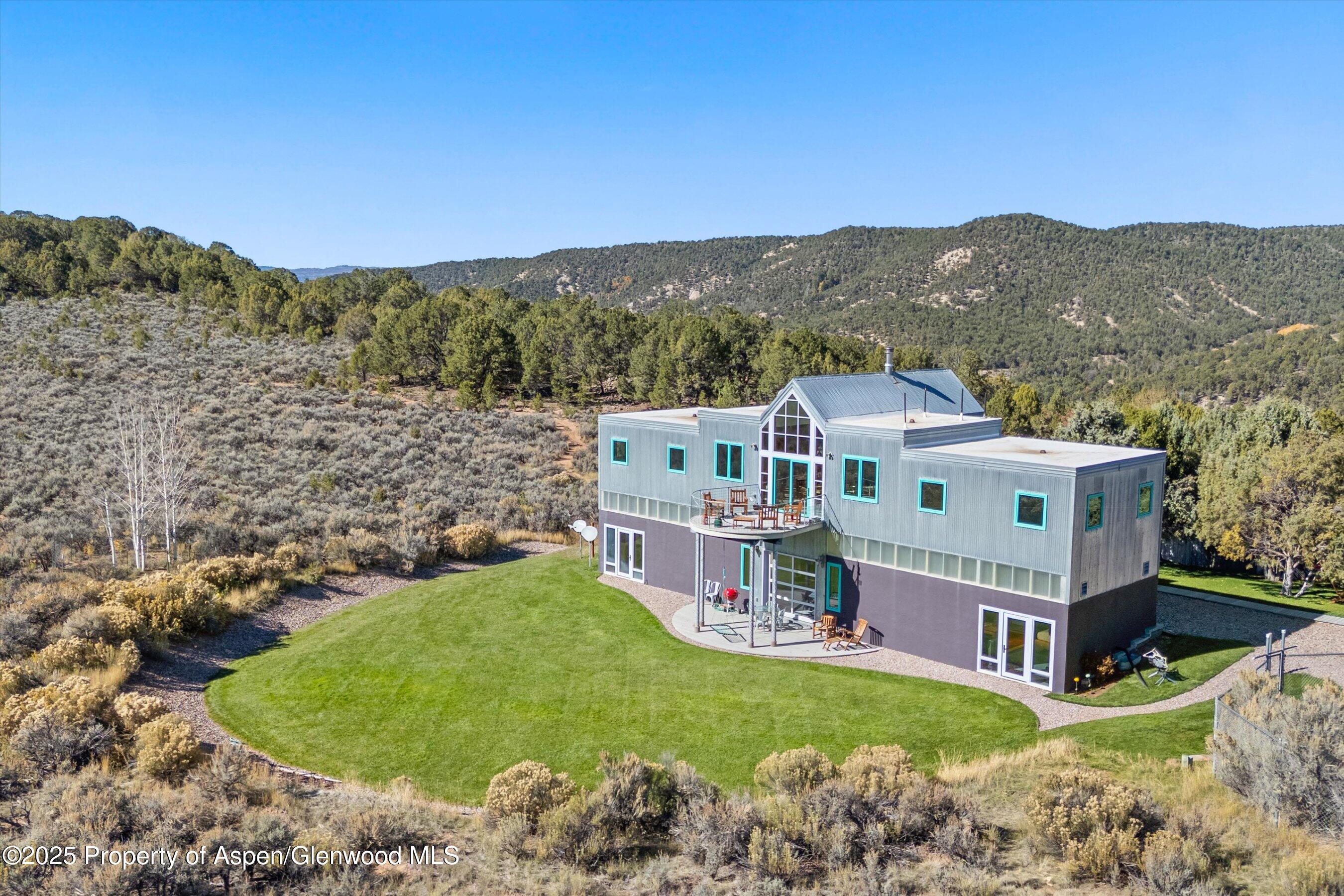 525 Cactus Flats Road Carbondale, CO 81623 - Photo 2 of 50 a view of a house with a mountain in the background