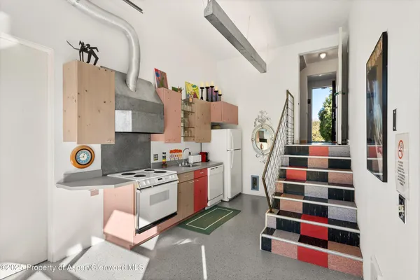 a kitchen with stainless steel appliances a sink and a stove