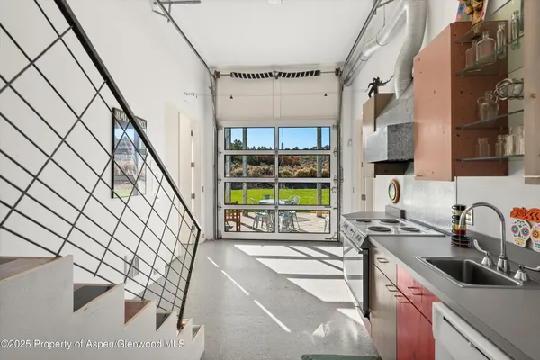 a kitchen with a sink a stove and a window