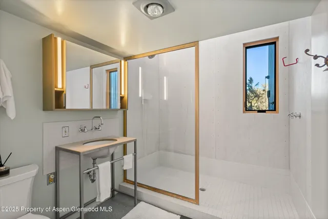 a bathroom with a sink mirror vanity and toilet