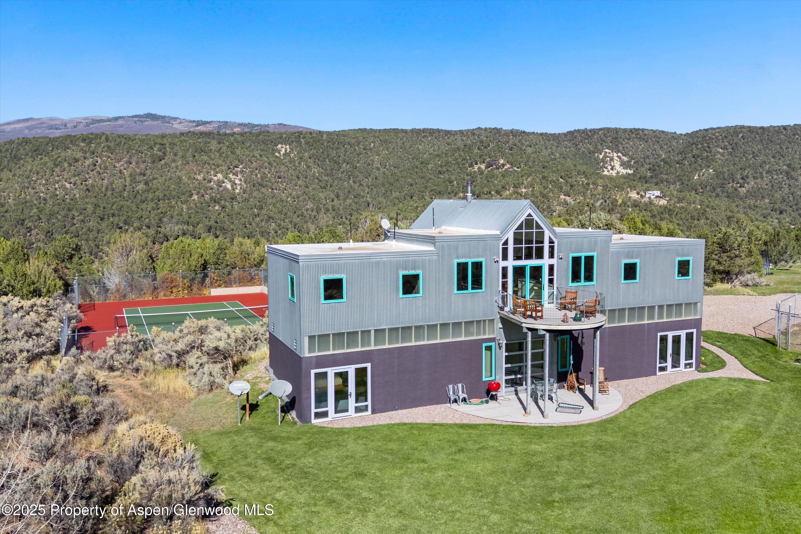525 Cactus Flats Road Carbondale, CO 81623 - Photo 3 of 50 a aerial view of a house with a big yard and large trees