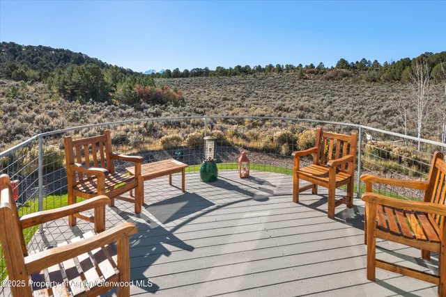 a view of a balcony with wooden floor and city view