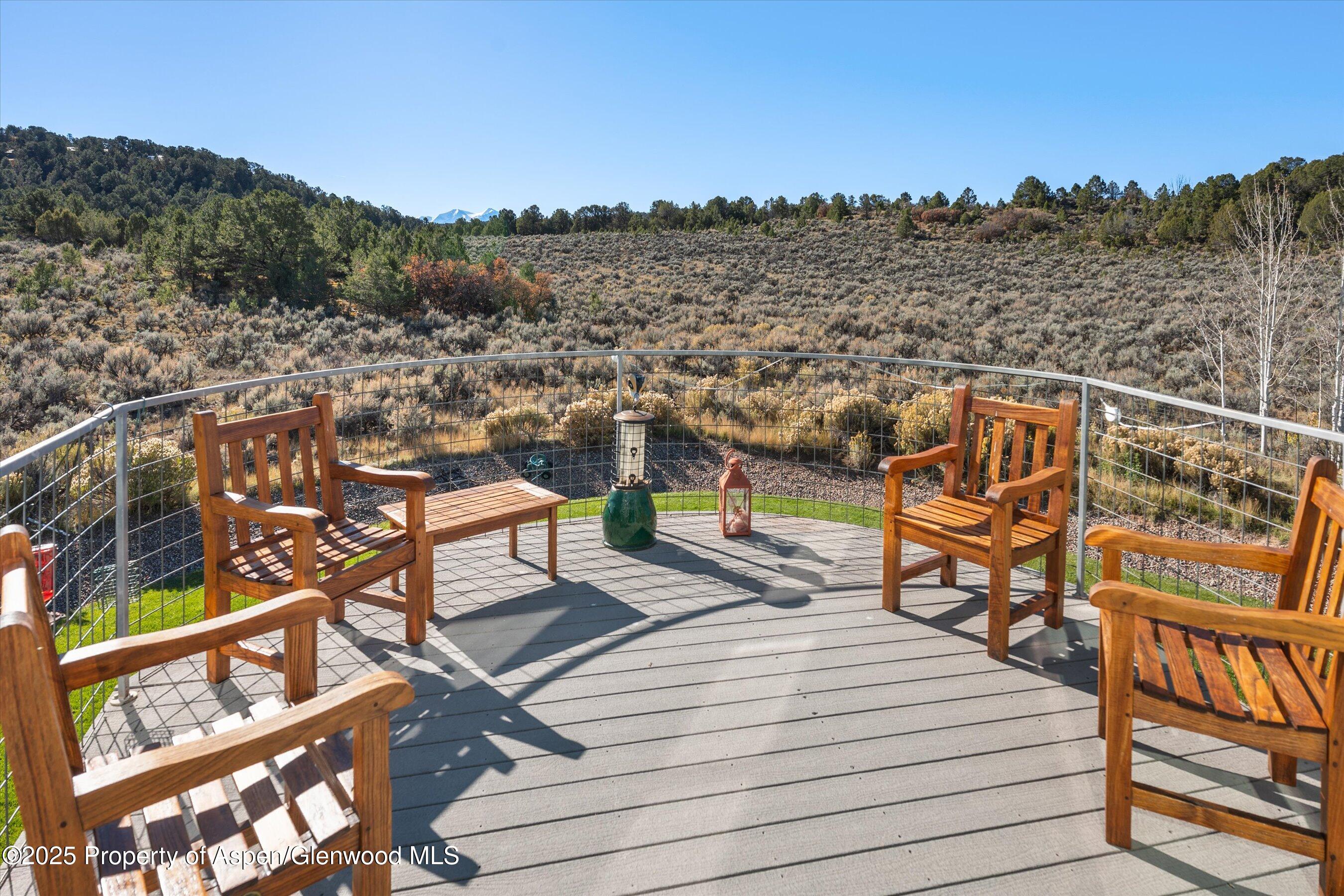 525 Cactus Flats Road Carbondale, CO 81623 - Photo 34 of 50 a view of a balcony with wooden floor and city view
