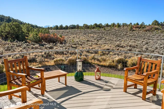 a view of a terrace with furniture and city view