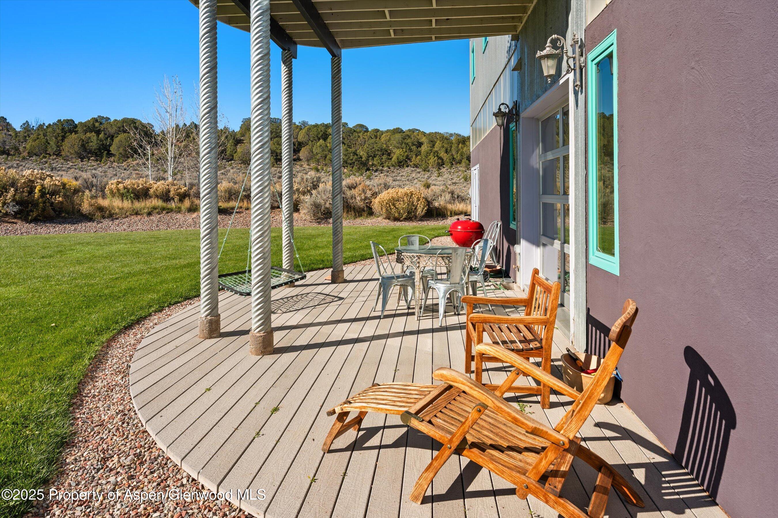 525 Cactus Flats Road Carbondale, CO 81623 - Photo 38 of 50 a view of a chairs and table in patio with a yard