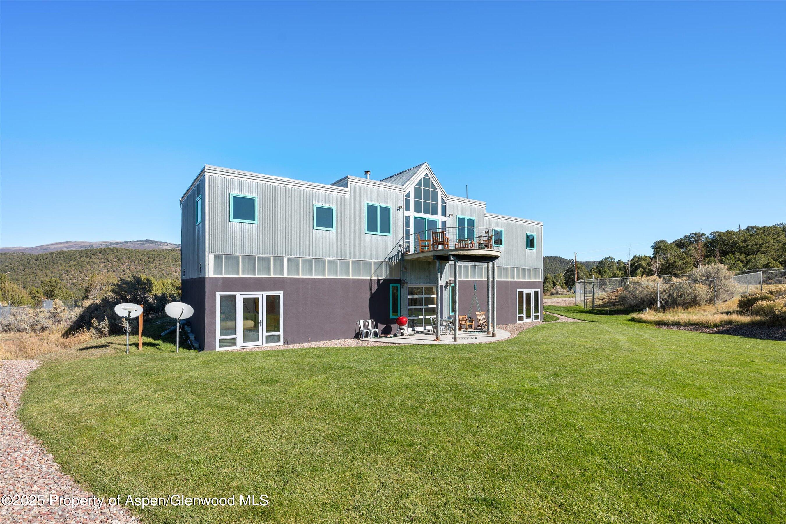 525 Cactus Flats Road Carbondale, CO 81623 - Photo 4 of 50 a view of a house with a big yard and large trees