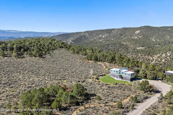 a view of a mountain with a back yard