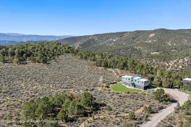 a view of a mountain with a back yard