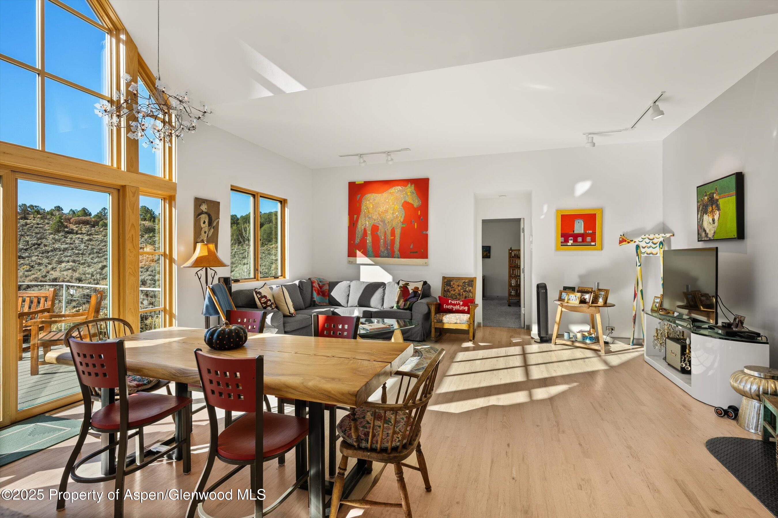 525 Cactus Flats Road Carbondale, CO 81623 - Photo 6 of 50 a view of a dining room with furniture a chandelier and wooden floor