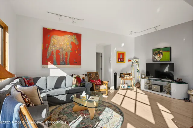 a living room with furniture and a flat screen tv