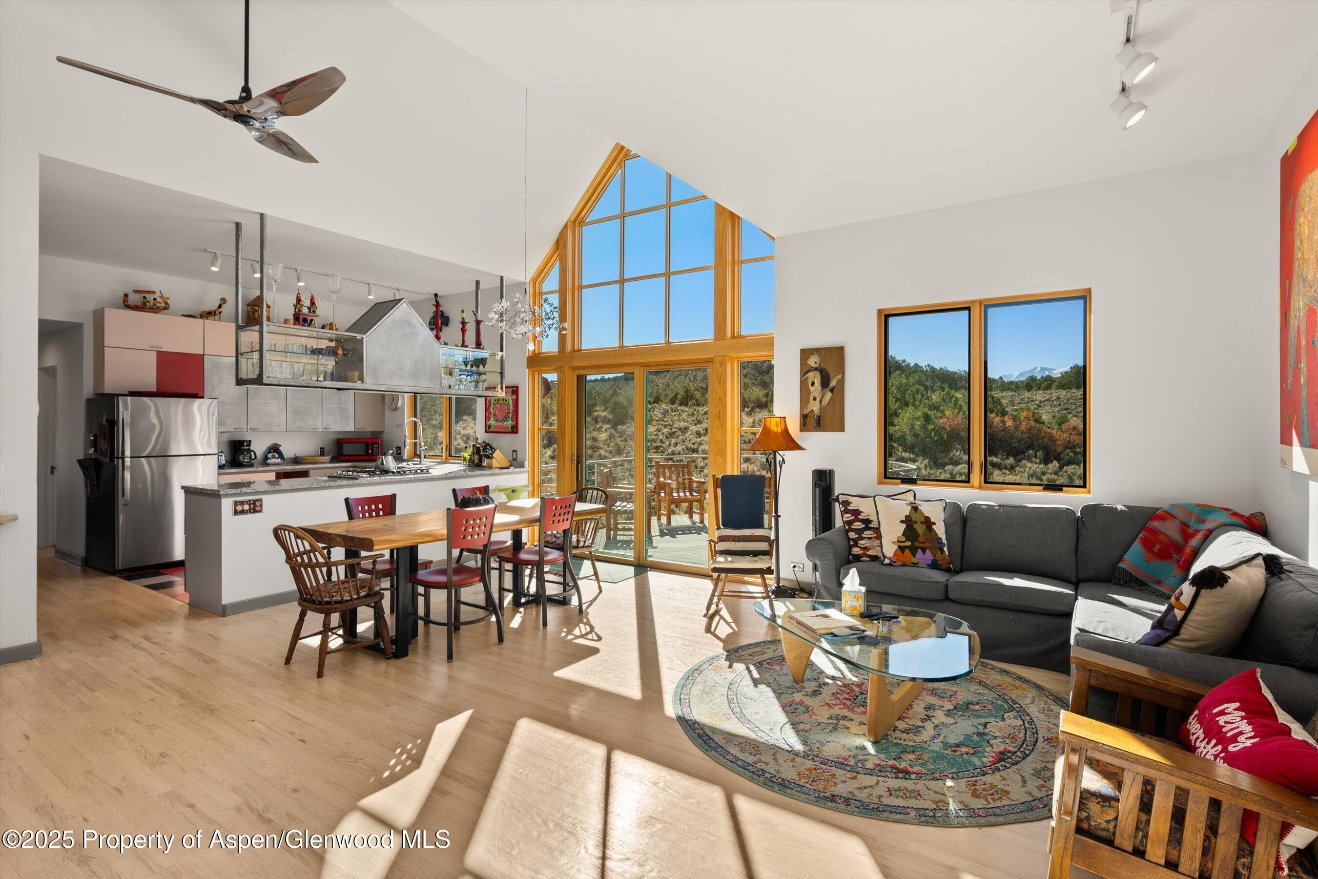 525 Cactus Flats Road Carbondale, CO 81623 - Photo 10 of 50 a living room with fireplace furniture and a large window