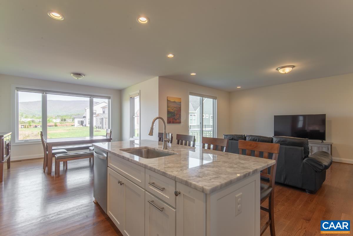418 Claibourne Road Crozet, VA 22932 - Photo 3 of 45 a kitchen with a table chairs refrigerator and sink