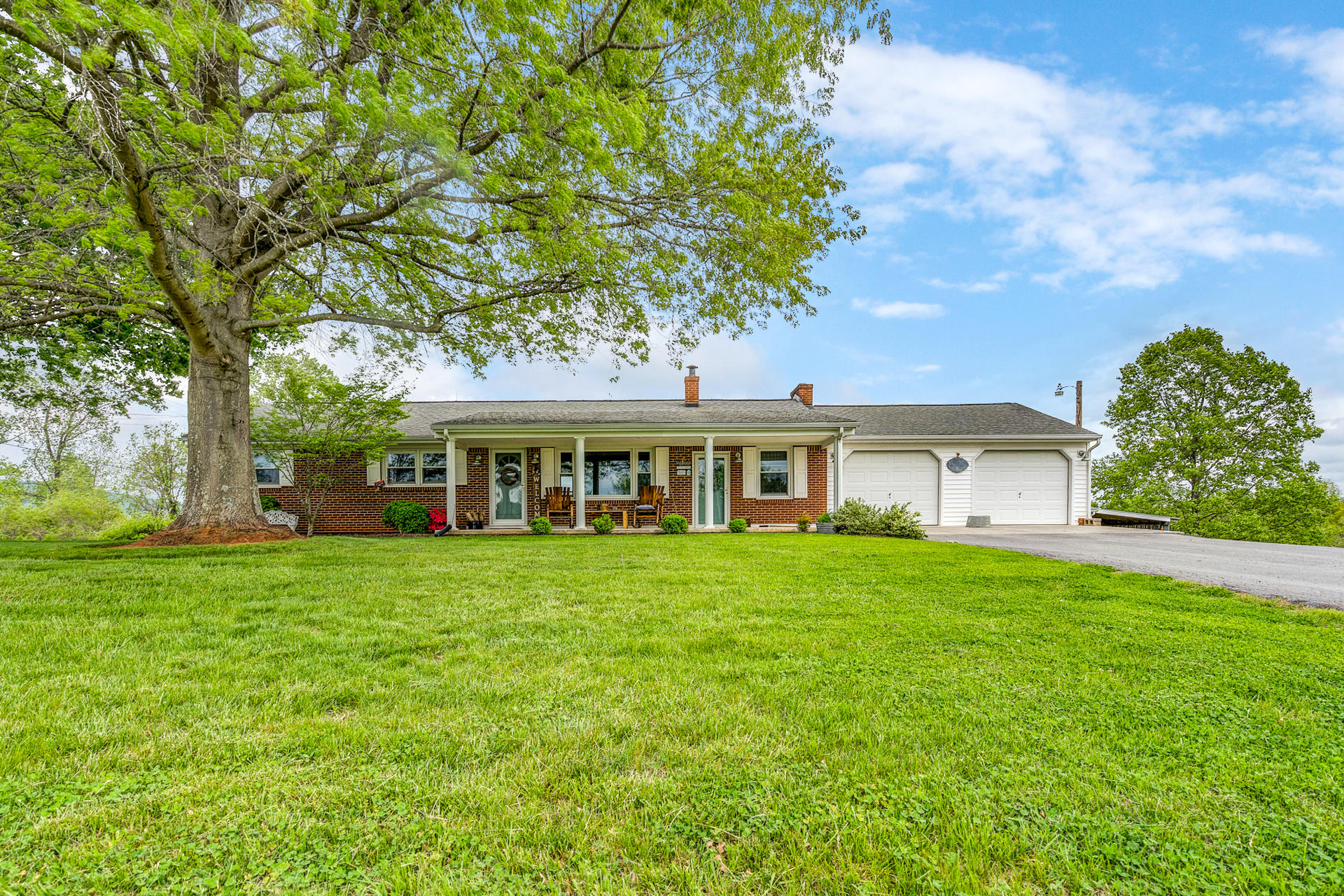1672 Blankenship Road Goodview, VA 24095 - Photo 1 of 39 a front view of a house with a garden
