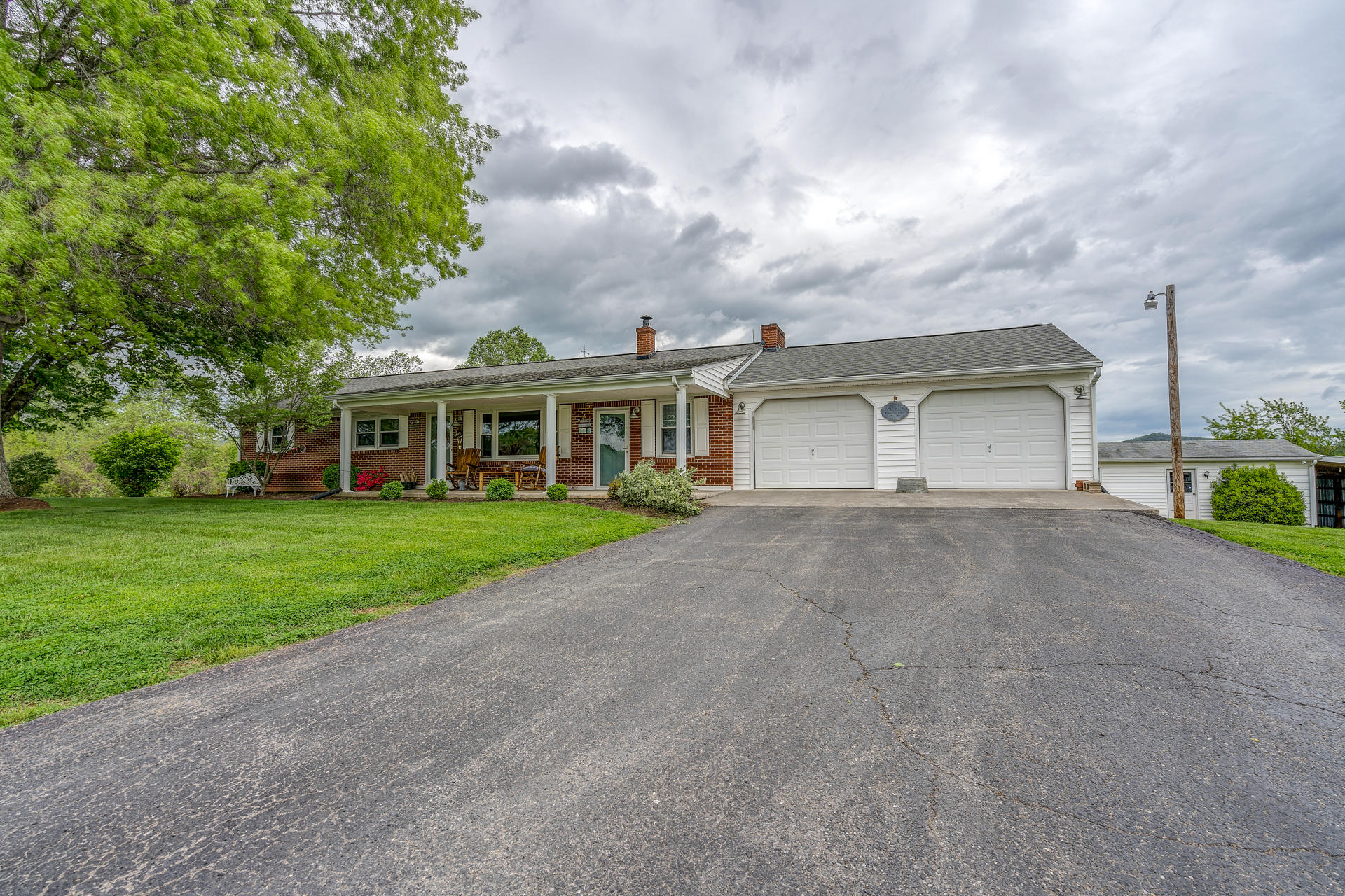 1672 Blankenship Road Goodview, VA 24095 - Photo 33 of 39 a view of a white house with a big yard and large tree