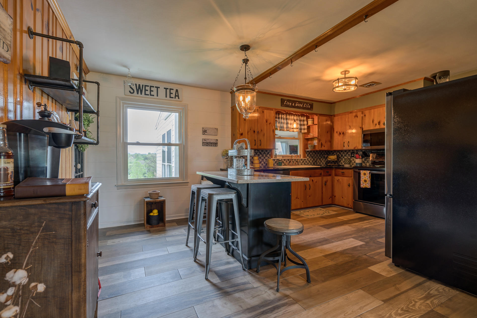 1672 Blankenship Road Goodview, VA 24095 - Photo 6 of 39 a kitchen with granite countertop a refrigerator a stove a sink dishwasher a dining table and chairs with wooden floor