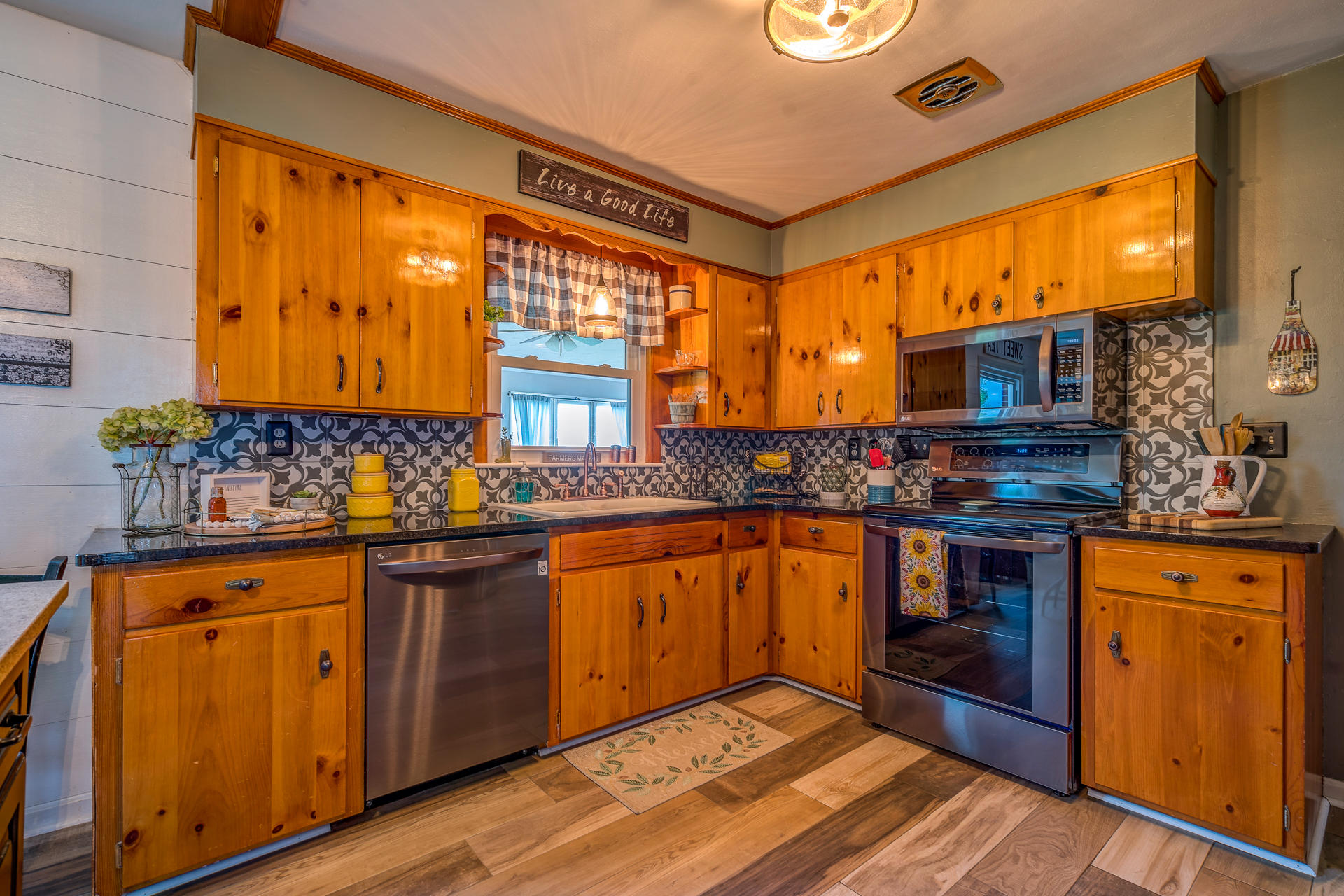 1672 Blankenship Road Goodview, VA 24095 - Photo 8 of 39 a kitchen with stainless steel appliances granite countertop a stove a sink and a microwave