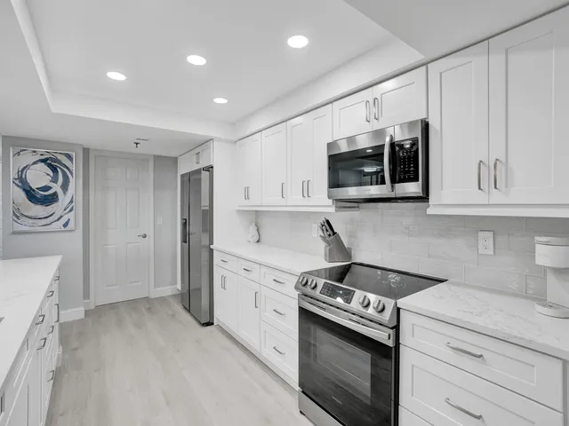 a kitchen with stainless steel appliances granite countertop a stove and a sink
