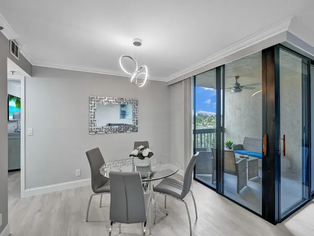 a view of a dining room with furniture and a chandelier
