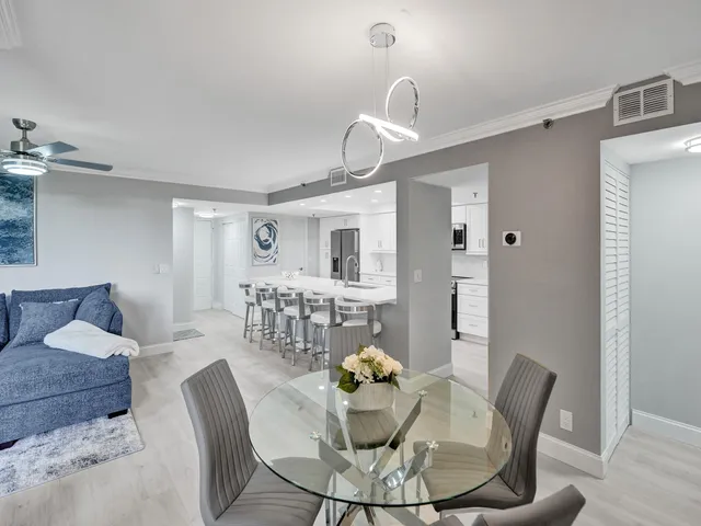 a living room with furniture and kitchen view