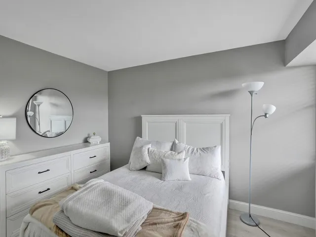 a living room with furniture and a mirror