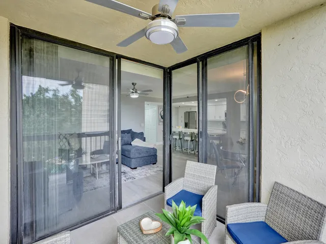 a view of hall way with furniture and a glass door