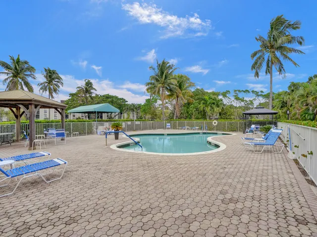 a view of a swimming pool with a table and chairs