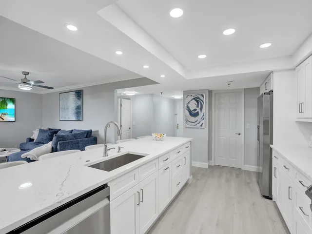 a kitchen with counter top space sink and natural light