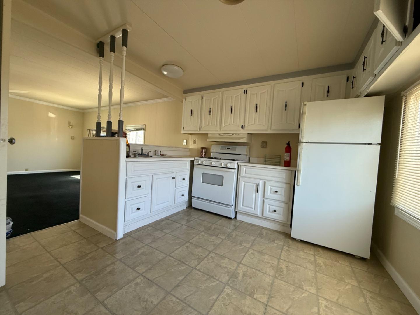 12350-147 Christensen Road, Unit 147 Salinas, CA 93907 - Photo 8 of 15 a kitchen with white cabinets and white appliances