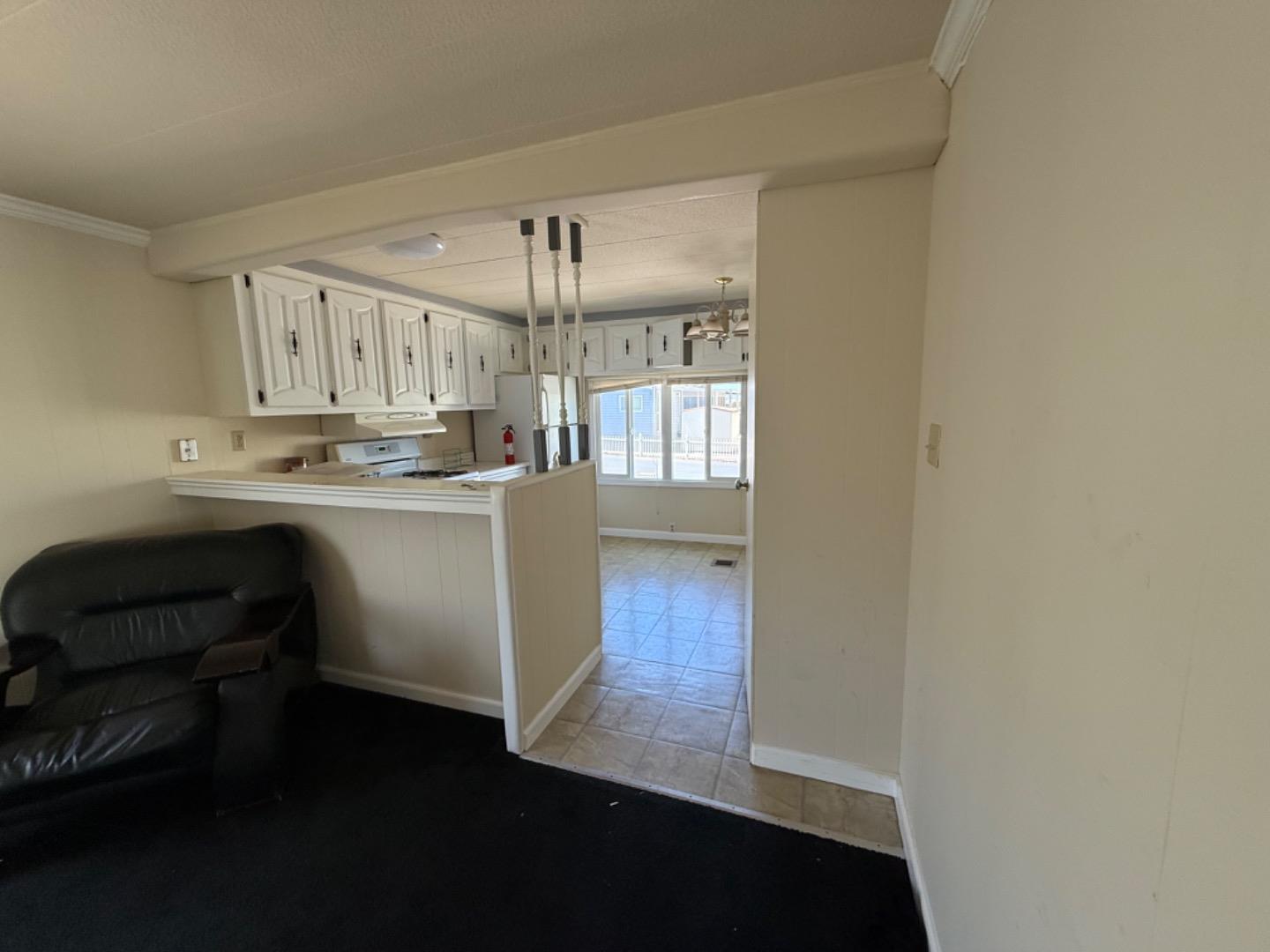 12350-147 Christensen Road, Unit 147 Salinas, CA 93907 - Photo 10 of 15 a kitchen with kitchen island white cabinets and stainless steel appliances