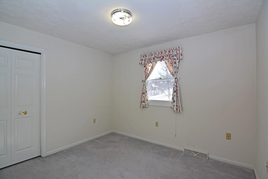 307 Blue Run Road Cheswick, PA 15024 - Photo 14 of 23 The second bedroom offers a sizable closet and neutral-toned paint.